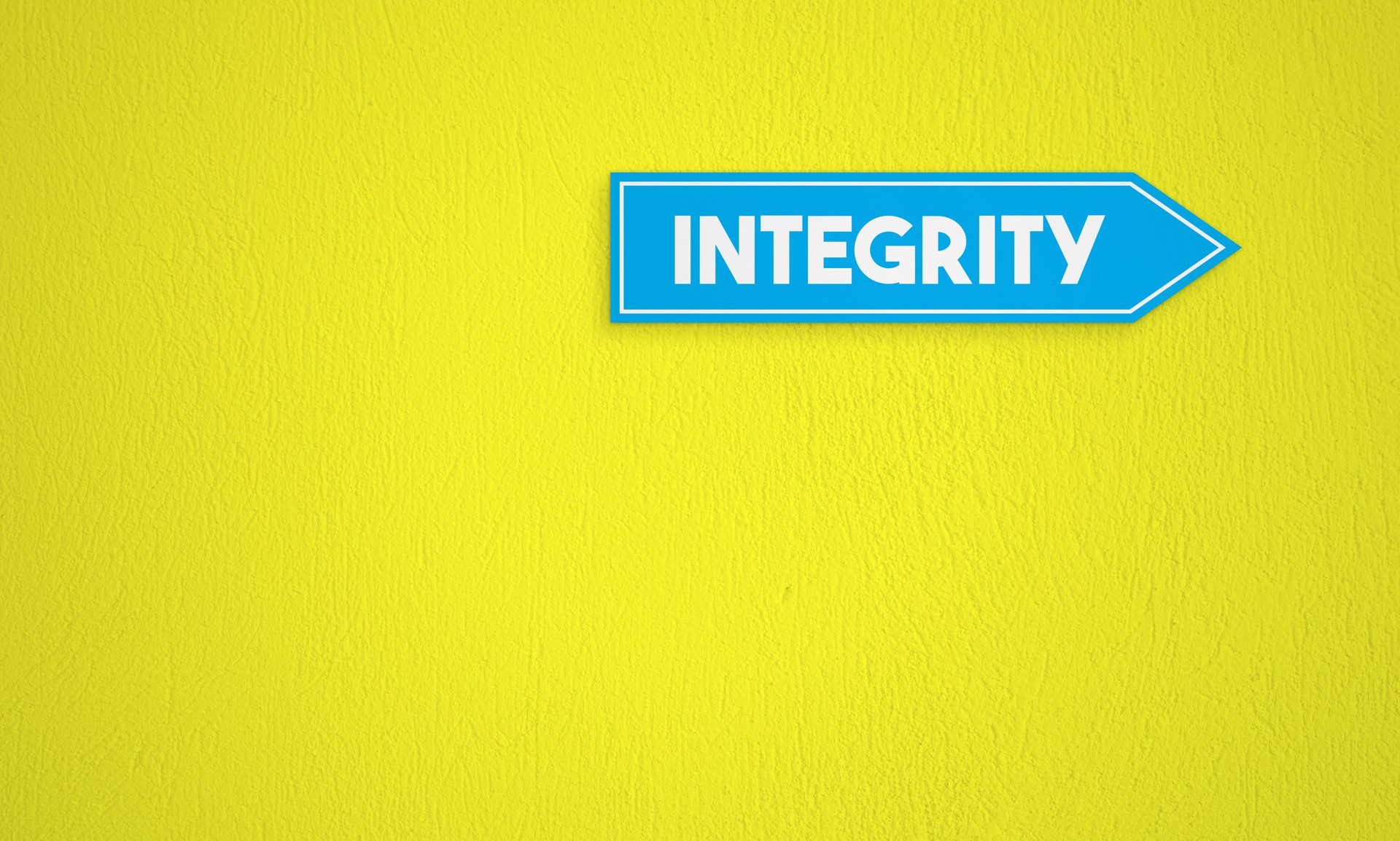 Integrity Directional Sign On The Yellow Wall Background